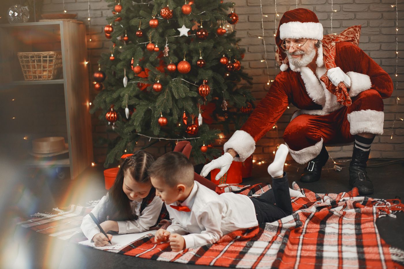 Bambini impegnati in attività creative natalizie insieme a Babbo Natale